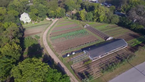 AERIAL:-360-Ascending-view-of-a-working-vegetable-farm-in-Austin,-Texas