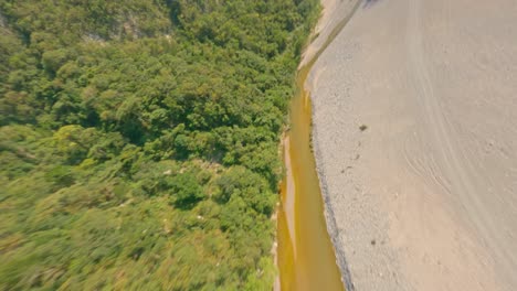 Aerial-fpv-flight-over-dried-river-between-mountains-in-Dominican-Republic-after-hot-summer---Climate-change-and-global-warming-on-planet