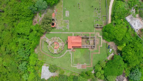 Top-View-Of-Sugar-Facility-Ruins-Surrounded-With-Green-Trees-In-Boca-de-Nigua,-Dominican-Republic