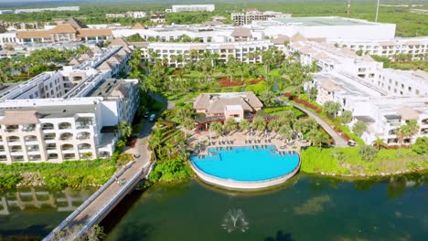 Aerial-view-of-hard-rock-complex-resort-with-private-swimming-pool-beside-river-in-Punta-Cana