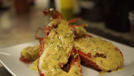 SLOWMO---Close-Up---Putting-a-gravy-on-a-cooked-New-Zealand-crayfish