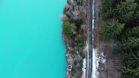 A-slow-slide-over-a-mountain-railways-near-an-iced-river