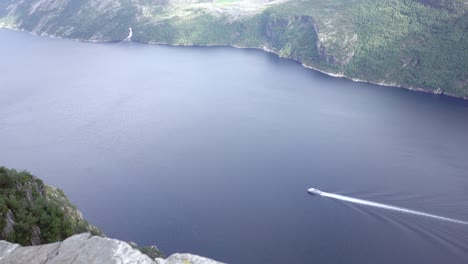 Extreme-Wide-shot-of-Norwegian-Fjord-with-Nice-Blue-Water-and-a-White-Boat-crossing