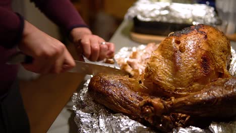 Slicing-a-turkey's-leg-with-a-knife-and-a-bear-claw-tool-then-putting-it-aside