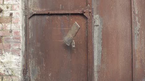 Old-rusty-metal-door-slams-shut