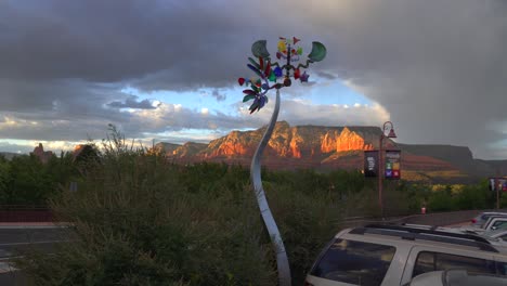 Colorful-wind-sculpture---wind-spinner-spinning-in-the-wind-near-the-road-in-Sedona,-Arizona
