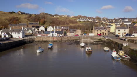 Aerial-footage-of-Gourdon-village-and-fishing-harbour-on-a-sunny-day,-Aberdeenshire,-Scotland
