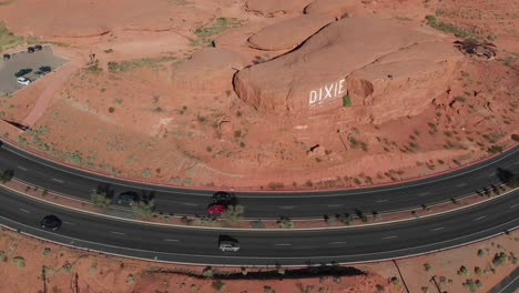 Drone-circles-around-red-rocks-and-road-in-southern-Utah