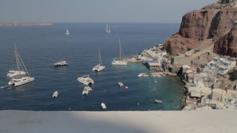View-from-above-of-the-small-fishing-harbor-Kamari,-in-Santorini