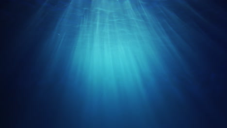 Underwater-sunlight-beams-shining-from-above-coming-through-the-deep-crystal-clear-blue-water-causing-a-beautiful-water-lighting-reflections-curtain