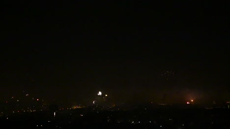 Fireworks-going-off-over-city-Bottom-Third-of-frame