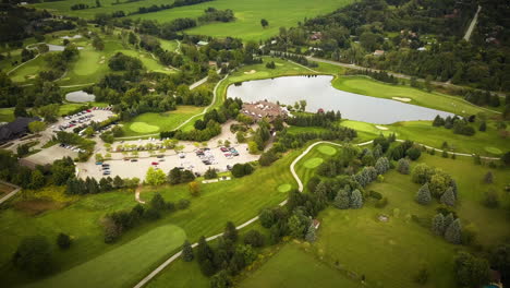 Beautiful-aerial-view-across-a-large-golf-course-surrounded-by-lush-fields