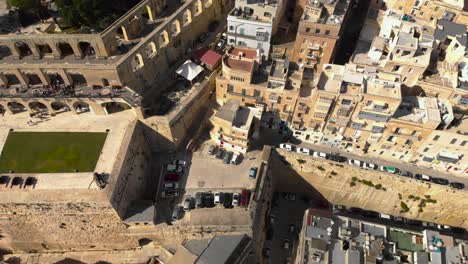 Aerial-shot-over-an-old-city-and-across-a-garden-on-the-edge-of-bastions