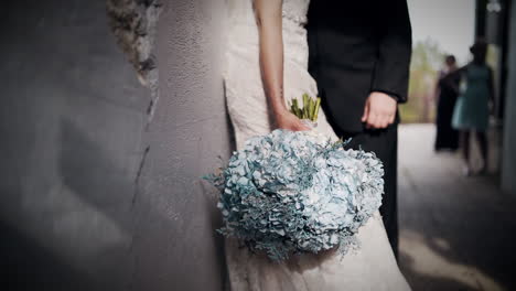 Beautiful-bride-holding-a-beautiful-bouquet-of-blue-flowers