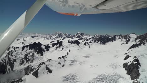 Snow-capped-rocky-mountains-in-Aoraki-Mountain-Cook-National-Park,-Southern-Alps,-New-Zealand-from-helicopter-scenic-flight