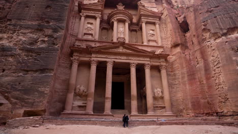 Panoramic-Shot-of-The-Treasury-Facade-Carved-Out-of-a-Sandstone-In-Ancient-City-of-Petra-with-Tourists-in-the-Background