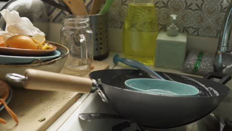 Close-Up-of-dirty-dishes-and-food-leftovers-in-the-kitchen-sink