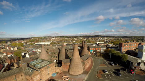 Aerial-footage,-view-of-the-famous-bottle-kilns-at-Gladstone-Pottery-Museum-in-Stoke-on-Trent,-Pottery-manufacturing,-industrial-decline-and-vacant-businesses