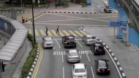 People-crossing-the-road-from-a-zebra-crossing-at-Kualalumpur