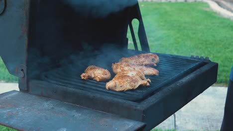 Various-shots-of-grilling-and-cooking-chicken-on-an-apartment-style-BBQ-grill