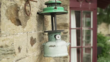 SLOWMO---Antique-vintage-historic-old-oil-lamp-on-stone-wall