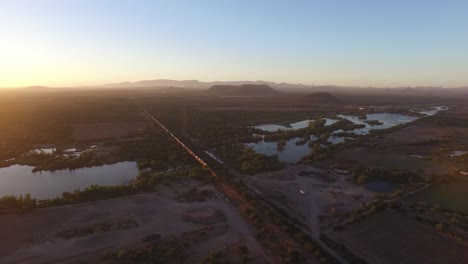 Aerial-shot-of-a-large-cargo-train-in-Sonora-at-Sunset