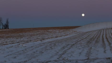 A-super-moon-overtop-of-a-snow-covered-field