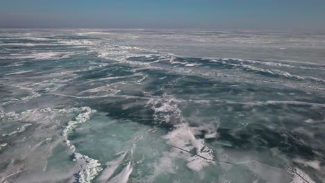 Flying-over-lighthouse-to-reveal-the-ice-and-shoreline-on-frozen-lake-Erie-in-January