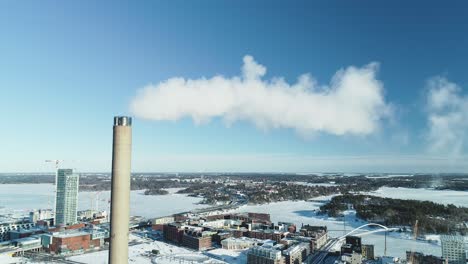 Static-aerial-shot-of-a-flue-gas-stack-in-Winter