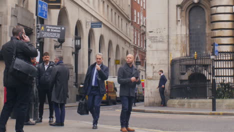 Young-male-using-smartphone-on-Lombard-Street-in-the-financial-district-of-London