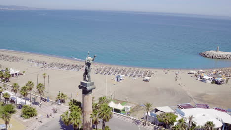 Arc-shot-of-statue-at-the-beach-in-Puerto-Banus,-Marbella