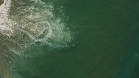 Afternoon-camera-down-drone-view-from-the-water-and-waves-of-Redondo-Beach,-California