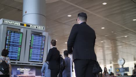 Man-looking-at-departures-board-at-the-Ben-Gurion-Airport-in-Israel