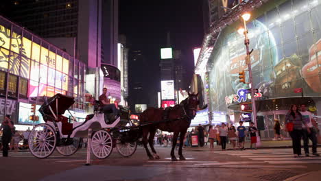 New-York,-NY---CIRCA-2016---A-man-in-a-horse-and-carriage-eagerly-awaits-his-next-customer-to-explore-Times-Square-in-Manhattan