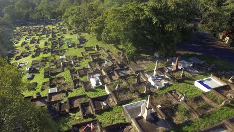 Aerial-drone-descending-shot-over-cemetery-to-reveal-broken-grave