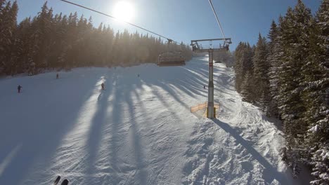 Ride-on-a-ski-lift-over-a-ski-track-placet-between-trees