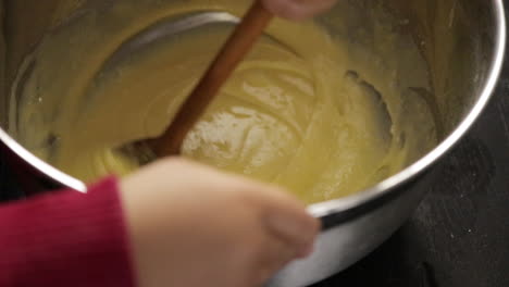 Children-making-a-cake-at-home,-close-up-soft-focus