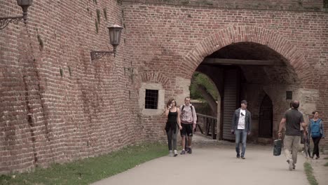 Tourists-walking-a-path-in-Belgrade-Fortress,-Serbia