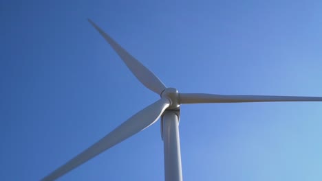 Detail-of-wind-turbine-rotating-around-with-blue-sky