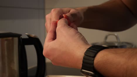 A-white-male-hand-model-peels-the-skin-from-tomatoes-in-slow-motion