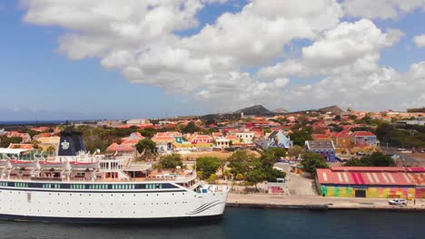 Revealing-aerial-of-a-scientologist-religious-retreat-ship-docked-in-the-harbour-of-St-Anna-Bay-Willemstad,-Curacao