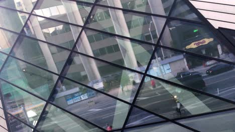 Reflection-of-early-morning-Bloor-Street-through-the-Royal-Ontario-Museum-windows