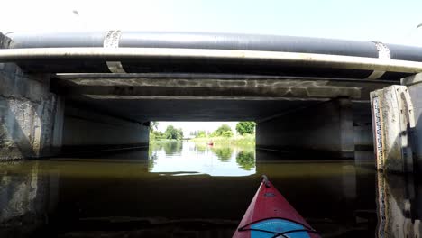 Swimming-under-the-bridge-in-kayak