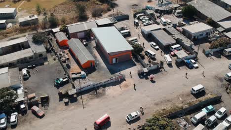 A-Push-In-Drone-Shot-of-a-Small-Industrial-Ware-house-Complex-In-Africa-on-a-sunny-day