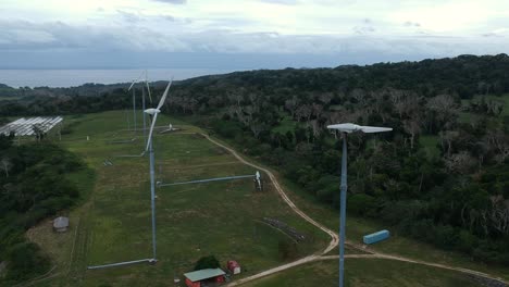 Aerial-view-of-a-wind-farm-situated-on-a-mountain-top-near-the-coastline-of-a-tropical-island-in-the-Pacific-ocean-region