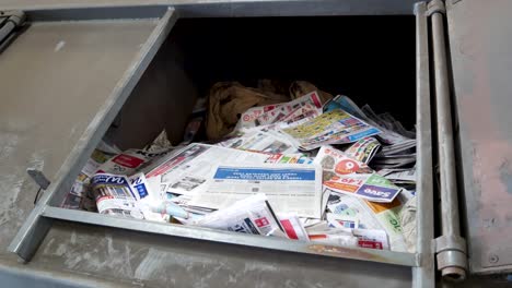 Newspapers-in-cycling-bin-in-recycling-center