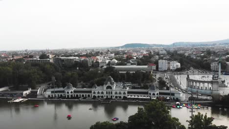 Cinematic-Drone-Shot-over-Lake-City-Park-Hotel-besides-Heroe's-Square-in-Hungary,-Budapest