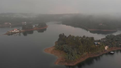 Aerial-view-of-small-tree-field-on-margin-of-lake-in-Tomar