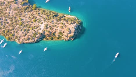 Aerial-drone-flying-over-the-mediterranean-sea-with-sailing-boats,-yachts-in-the-bay-lagoon