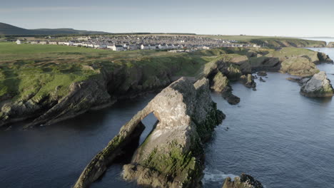 An-aerial-view-of-Bow-Fiddle-Rock-at-Portknockie-on-a-calm-summer's-morning